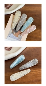 Detail showing high-quality acetate hair clips with crystal trim and woven texture finish