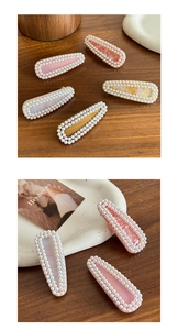 Detailed macro view of pearl-encrusted acetate hair clips in pink and marble patterns