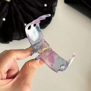 Elegant acetate hair claw with purple marble texture and durable metal spring