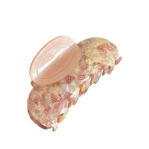 Pink marble acetate hair claw clip with floral pattern and glossy resin finish