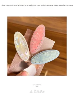 Detail of marble pattern acetate hair clips with sparkling rhinestones in soft colors