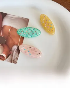 Detailed macro view of colorful rhinestones on acetate oval hair clips set