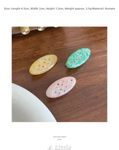 Detail of colorful rhinestones on acetate oval hair clips in a vintage setup