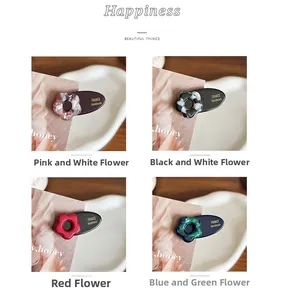 Detail showing four assorted floral acetate hair clips with France Handmade engraving