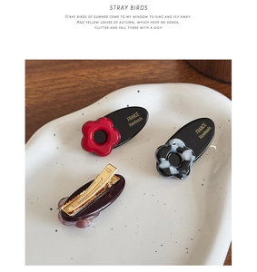 Detail of France Handmade acetate hair clip with floral patterns and gold metal beak clip