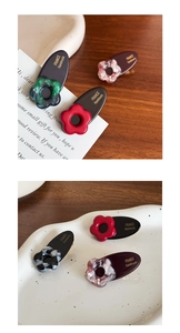Detail of floral acetate hair clip showing the smooth surface and gold handmade logo