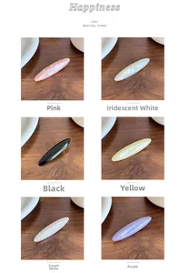 Detail view of 6 colorful resin duckbill hair clips with a glossy finish on a wooden desk