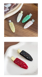 Detailed macro view of colorful acetate hair clips with inlaid rhinestones and marble texture