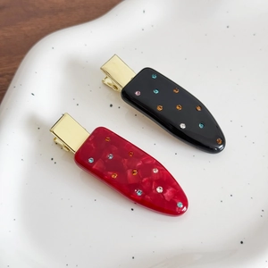 Elegant acetate hair clips set with colorful rhinestones in red marble and black finish