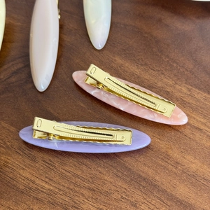 Minimalist acetate hair clips in purple and pink with gold metal alligator grip