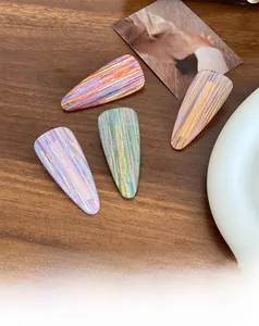 Macro shot of colorful acetate teardrop hair clips on dark wood background