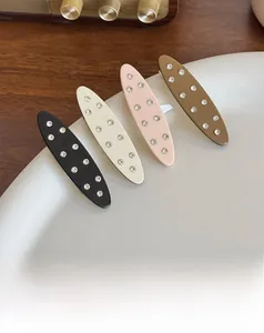 Detailed macro view of four acetate geometric hair clips with sparkling rhinestones set on metal