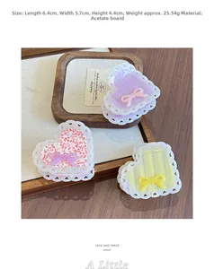 Detailed view of acetate heart hair claws with bow accents in floral and striped patterns