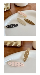 Close-up of four rhinestone-embellished acetate hair clips in neutral colors and duckbill clip detail