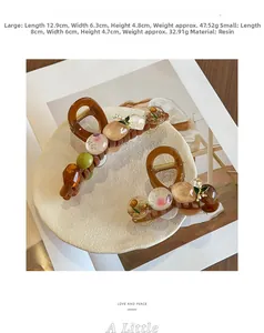 Detail of amber resin hair claw clips with embedded floral beads in two sizes