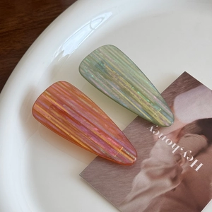 Set of two colorful acetate teardrop duckbill hair clips in orange and cyan stripe finish