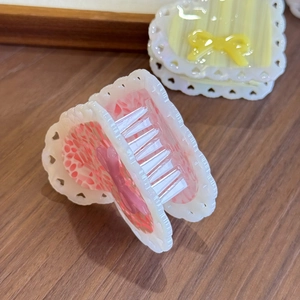 Elegant heart-shaped acetate hair claw clips with floral patterns and lace edge details