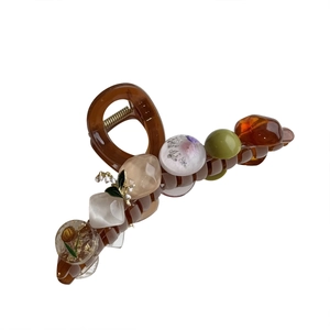 Retro amber resin hair claw clip with assorted beads and metallic flower accents