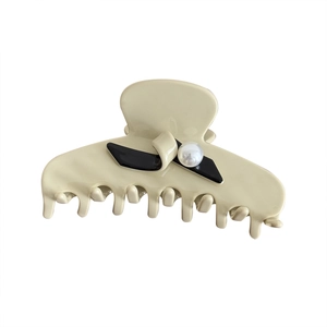 French cream pearl hair claw clip with black bow accent and elegant resin design
