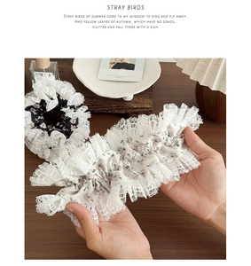Detail view of floral print hair scrunchies with elegant white lace embroidery edges