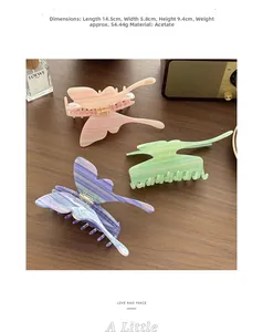 Detailed view of large acetate butterfly hair claws with elegant marble textures