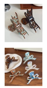 Detail of elegant acetate hair claws featuring tortoiseshell patterns and bow shapes