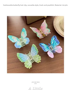 Detail of four acrylic butterfly hair claws with floral patterns on a wooden desk