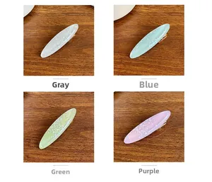 Detailansicht ovaler Acetat-Haarspangen in Grau, Blau, Grün und Lila mit feinem Glitzer