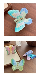 Detail of colorful gradient butterfly hair claw clip with floral pattern and metal spring