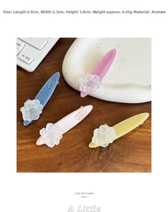 Detail of colorful acetate camellia flower hair clips showing 6.9cm size and glitter texture