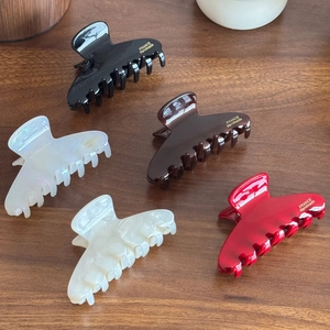 Elegant medium acetate hair claws in 5 colors with gold handmade labels on wood