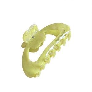 Pale yellow flower hair claw clip with diamond accents and elegant acetate marble texture