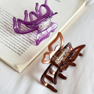 Elegant butterfly acetate hair claws in jelly purple and amber brown with hollow design