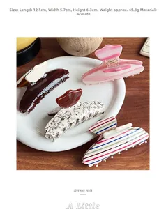 Close-up of assorted patterned acetate hair claws including marble and rainbow stripes