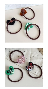 Close-up of heart-shaped hair ties with vintage gold accents and high-elastic bands