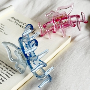 Elegant jelly-colored butterfly hair claws in translucent blue and pink resin finish