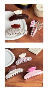 Detailed view of large acetate hair claws with various marble and striped textures