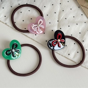 Three-piece hair tie set with vintage heart bow charms in pink, green and black colors