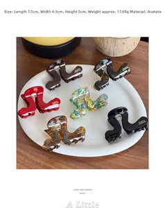 Detail view showing assorted acetate hair claws with dimensions 7.7x4.5x5cm and weights