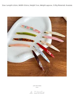 French style tortoiseshell acetate hair clips displayed on a ceramic plate