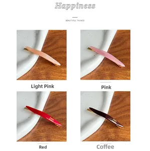 Detailed set of acetate spring hair clips in pink, red, and coffee with gold handmade text