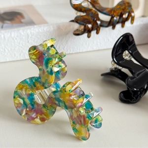 Minimalist acetate hair claw clip with colorful ink marble texture and S-shaped wave design