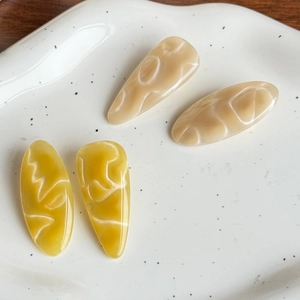 Elegant water ripple hair clips set in cream and mustard colors with marble texture