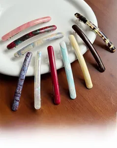 Detail view of acetate spring hair clips with various marble and tortoise shell patterns