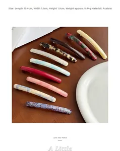 Detail view of acetate spring hair clips measuring 10.6cm in marble and tortoiseshell patterns