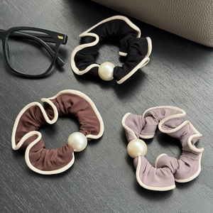 Three-piece set of elegant pearl hair scrunchies in black, coffee, and mauve with white piping