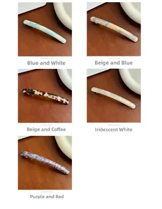 Detail view of five acetate spring hair clips with marble and tortoiseshell patterns