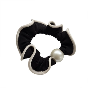 Elegant black and white satin scrunchie with large pearl accent for ponytail styling