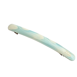 Elegant blue marble acetate spring hair clip with gold lettering in a diagonal view
