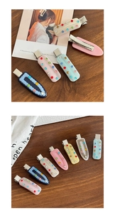 Detail of colorful rhinestones on pastel acetate hair clips with silver metal duckbill base